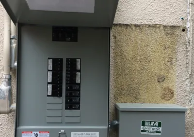 A breaker box on the side of a building.