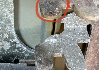 A piece of metal with a red circle on it.